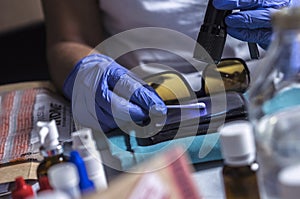 Police specialist examines wallet to collate DNA in a crime scene