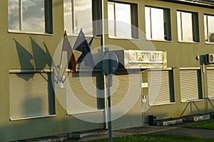 The police station building with a sign - Police and the flags of Lithuania and the European Union hanging on the