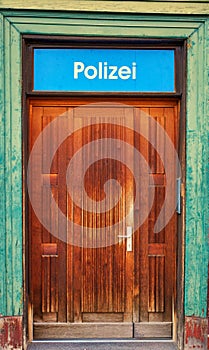 Police station sign as text in German letters over an old door