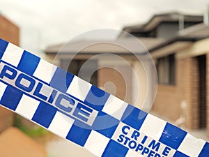 Police tape cordoning off a building site like a crime scene photo