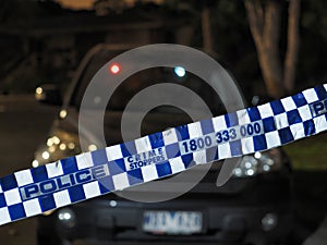 Police tape cordoning off a car after dark photo