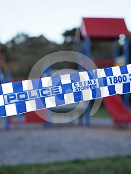 Police tape cordoning off an colorful playground area photo