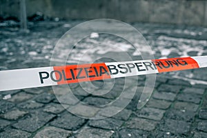 Police tape in Germany at the crime scene with the inscription in German police cordon. Crime Scene.