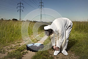 Police technician dressing DNA free suit in fields