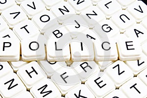 Police text word crossword. Alphabet letter blocks game texture background. White alphabetical cubes blocks letters on