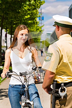 Police - woman on bicycle with police officer