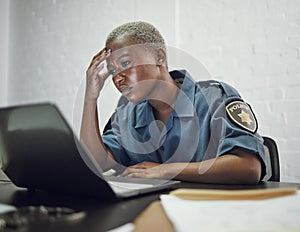 Police, woman and headache from working with stress on computer or frustrated with case, report or anxiety in security