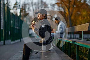 Police woman take break eating in park