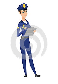 Police woman in uniform writing on clipboard.