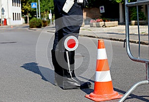 Policeman with black boots and paddle traffic