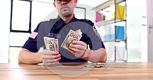 Policeman counts dollars in police station