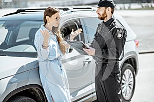 Policeman with female driver on the roadside