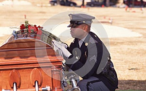 Policeman grieves over coffin of his friend and fellow officer