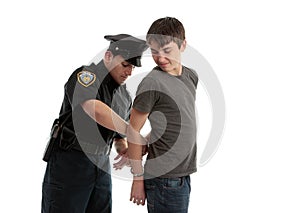 Policeman handcuffing teenager