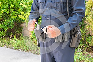 Policeman Holding Handcuffs