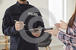 Policeman interrogating woman or witness regarding police investigation