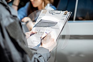 Policeman issuing a fine for a female driver