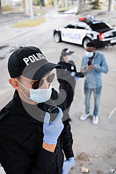 Policeman in latex gloves and medical