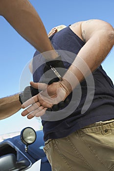Policeman's Hands Arresting Criminal