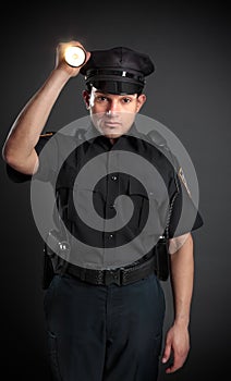 Policeman or Security Guard shining a torch photo