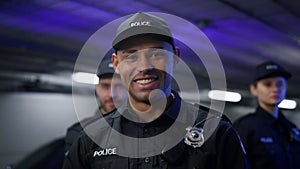 Policeman smiling at camera. Positive cop in uniform posing at camera