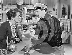 Policeman standing in at a counter in a general store