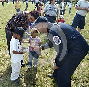 A policeman talks to little children