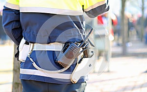 policeman in uniform with a radio transmitter and gun during a d