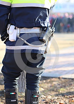 policeman in uniform with a radio transmitter and gun photo