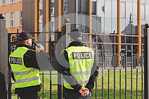Policemen stand in front of the entrance gate to the house during home intervention