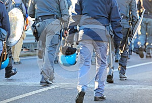 policemen in uniform with riot gear during the protest demonstration with helmets and shields