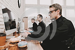 Policemen Working On Computer In Police Station.