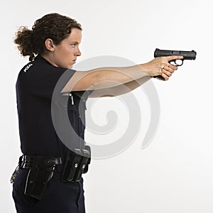 Policewoman aiming gun.