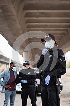 Policewoman in latex gloves and medical