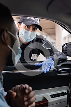 Policewoman in medical mask and latex