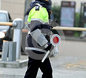 Policewoman with the paddle while directing traffic
