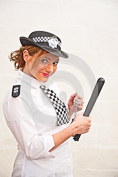 Policewoman in uniform with truncheon photo