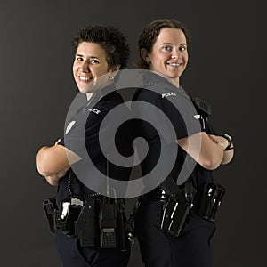 Policewomen back to back.