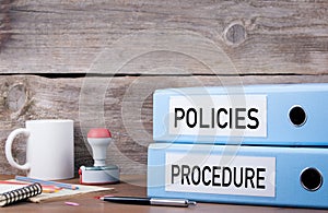 Policies and Procedure. Two binders on desk in the office. Business background photo