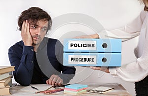 Policies and Procedure - two binders in the hands of women