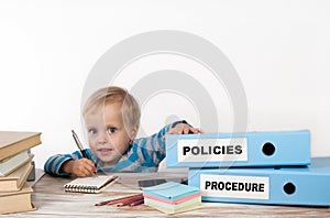 Policies and Procedure - young boy with stack of two office bind