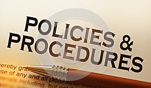 Policies and procedures memo on notebook with pen. Business concept