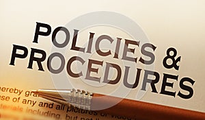 Policies and procedures memo on notebook with pen. Business concept photo