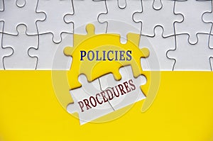 Policies and procedures text on missing jigsaw puzzle. Business policies concept