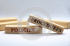 Policies and procedures text on wooden blocks on white cover background. Policy and procedure concept.