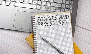 POLICIES AND PROCEDURES text written on a notebook on the laptop,business