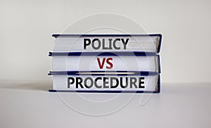 Policy vs procedure symbol. Books with words `Policy vs procedure` on beautiful white table, white background. Business and poli