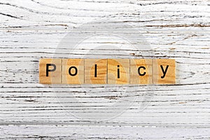 Policy word made with wooden blocks concept