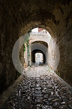 Stone tunnel i old city Polignano mare apulia city street in Italy photo