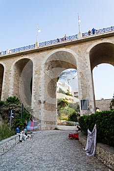 People on the Ponte Lama Monachile bridge in Polignano a Mare, Italy.